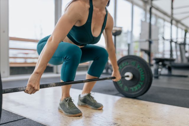 photo of a barbell squat or dumbbell row being performed with correct form. 